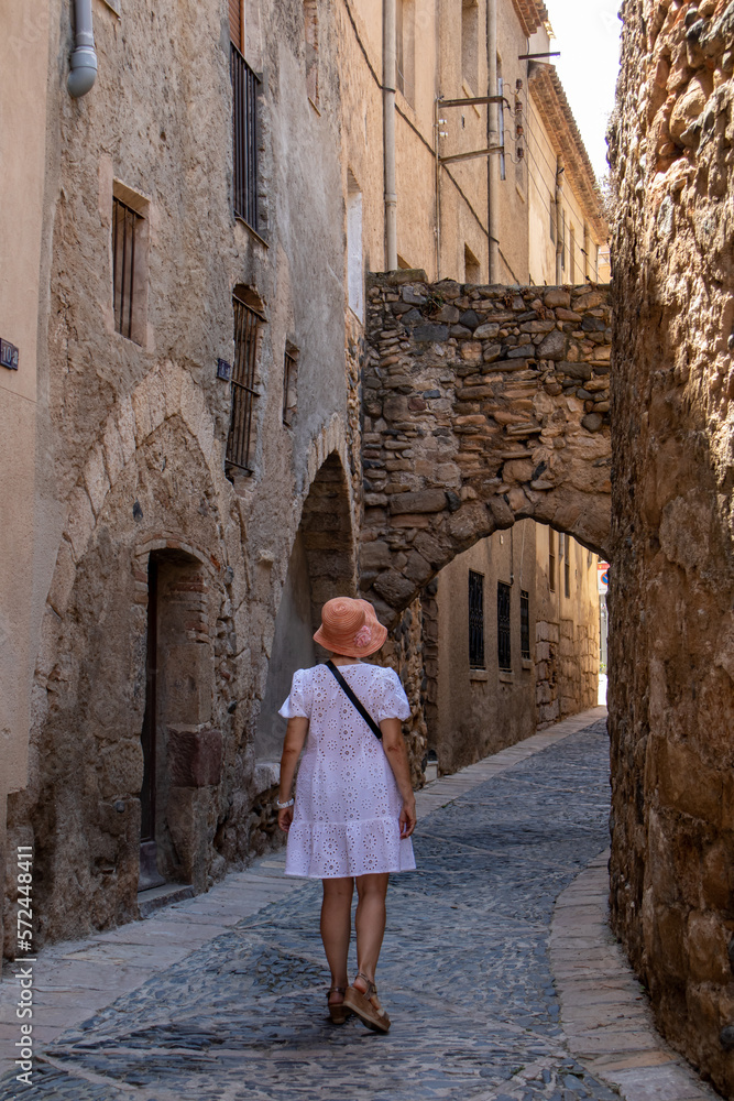 Street with tourist in the medieval city of Montblanc, Tarragona. Beautiful walled villa