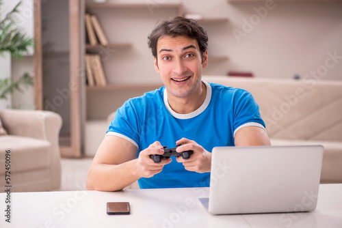 Young man playing video games at home