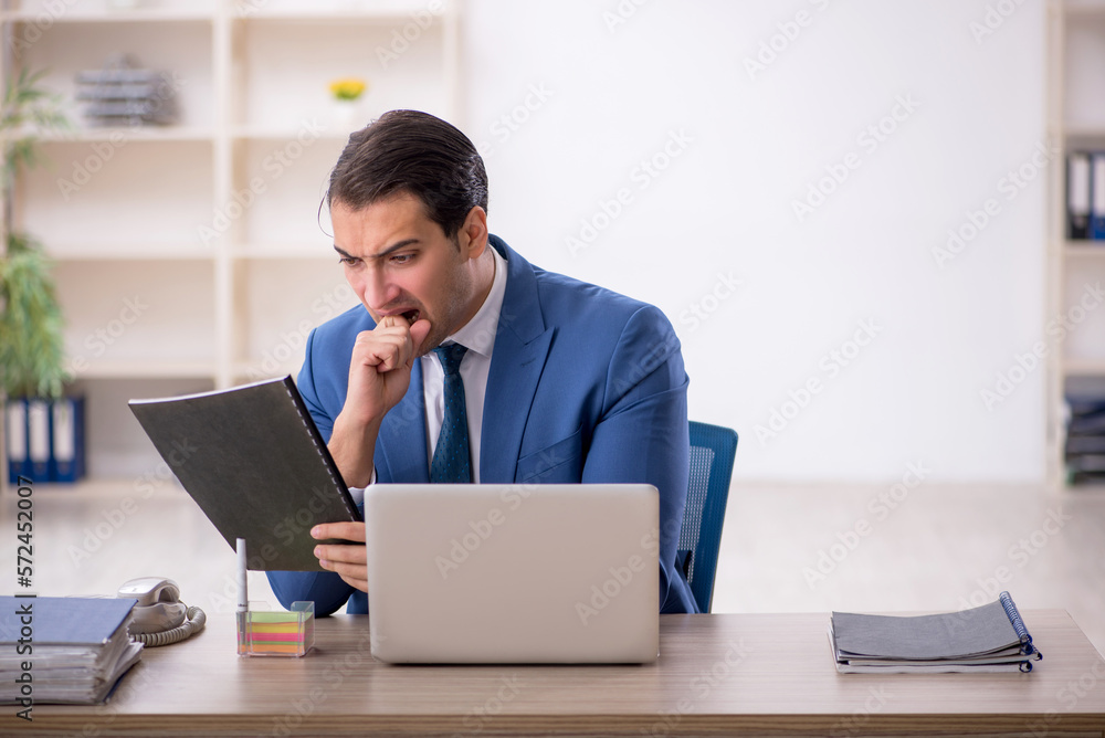 Young male employee working in the office Young male employee working in the office
