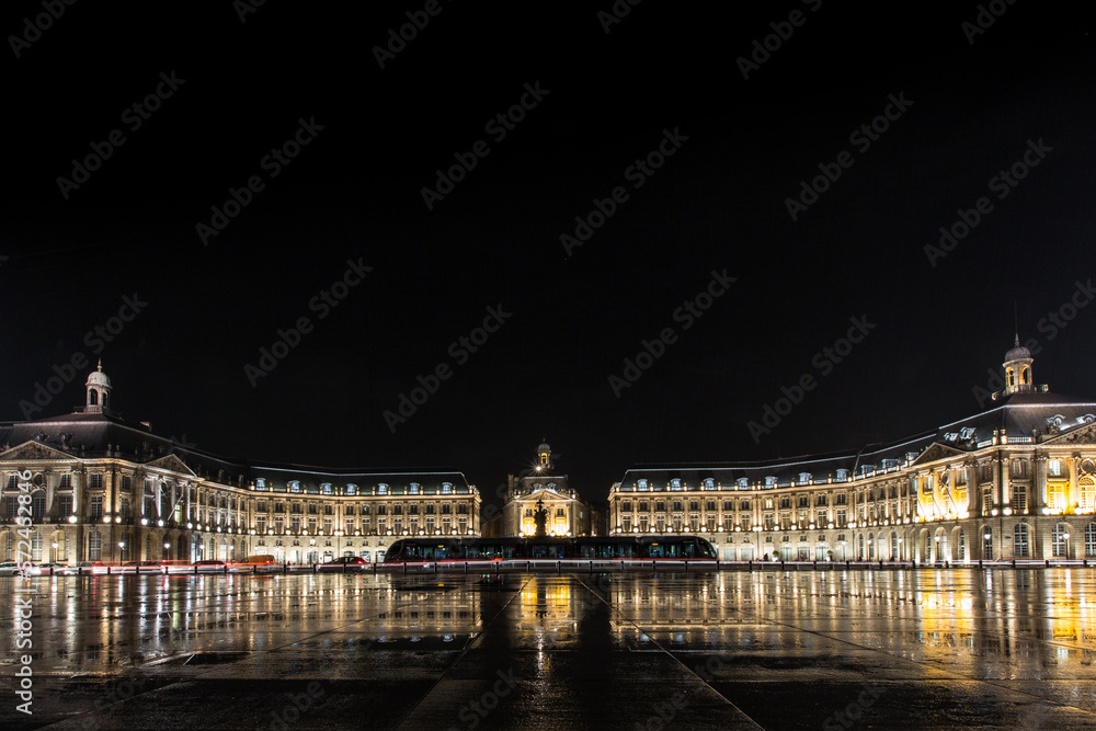 city of bordeaux bynight with the famous place de la bourse illuminated with a tramway in the center of the place