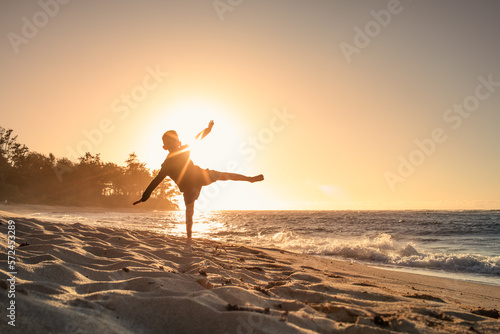 Happy child playing on the beach. Kid having fun outdoors. Summer vacation and healthy lifestyle concept.
