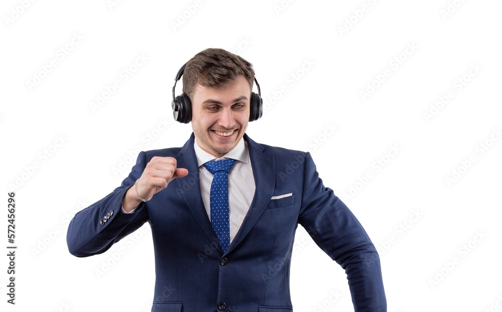 Dancing handsome man in business suit with headphones. The concept of freedom in business. In the studio on a white background. Dancing handsome man in business suit with headphones. The concept of freedom in business. In the studio on a white background.
