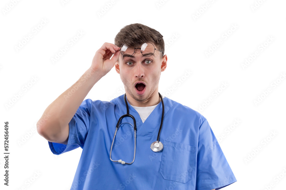 Doctor in uniform and with a stethoscope shows emotions of surprise and horror by opening his mouth and raising his glasses. Doctor in uniform and with a stethoscope shows emotions of surprise and horror by opening his mouth and raising his glasses.