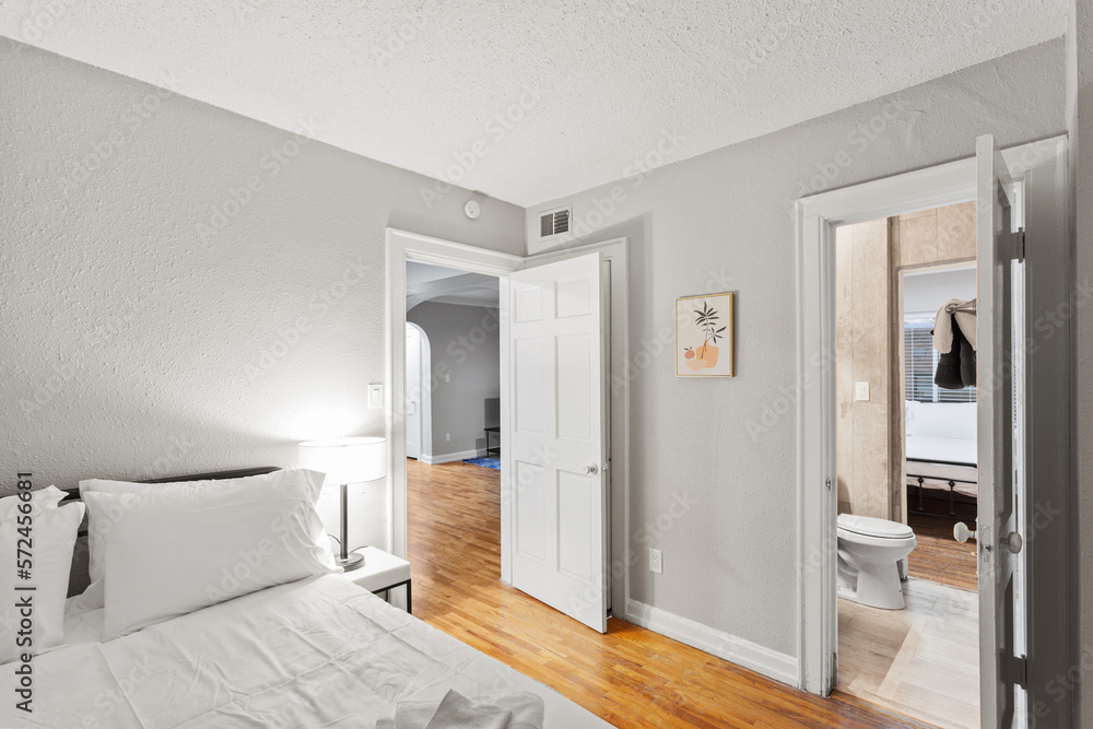 White apartment with wide open spaces, hardwood flooring and modern furniture. Used as a short term rental. White apartment with wide open spaces, hardwood flooring and modern furniture. Used as a short term rental.