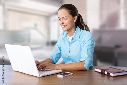Young business woman at work with laptop.