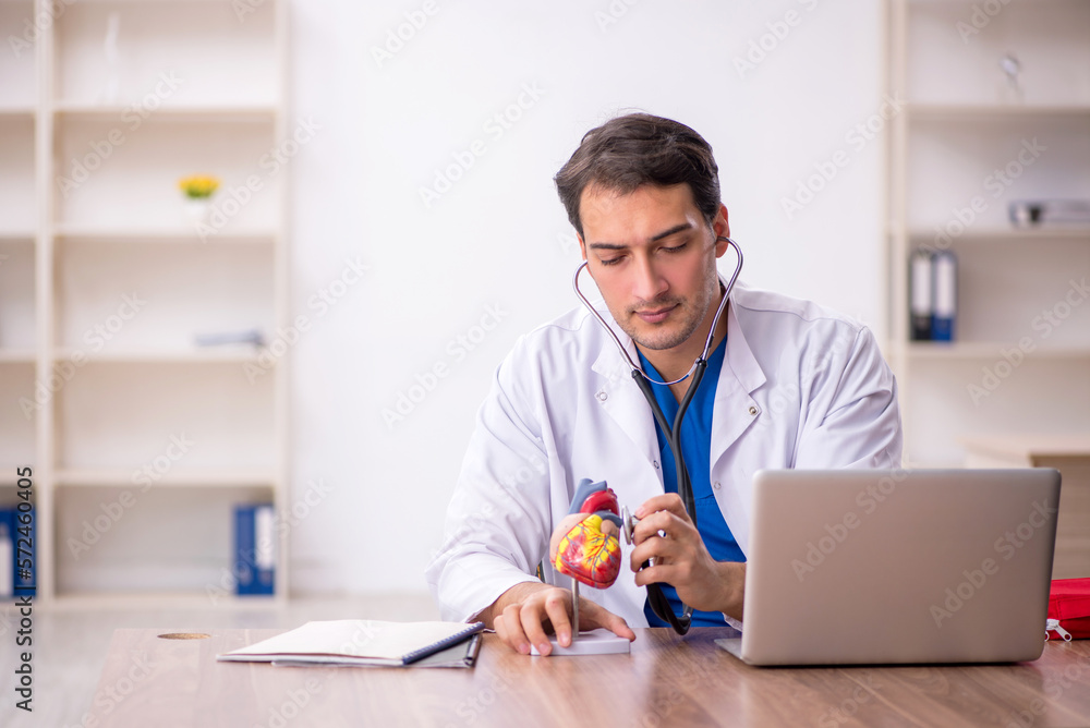 Young male doctor cardiologist working in the clinic Young male doctor cardiologist working in the clinic
