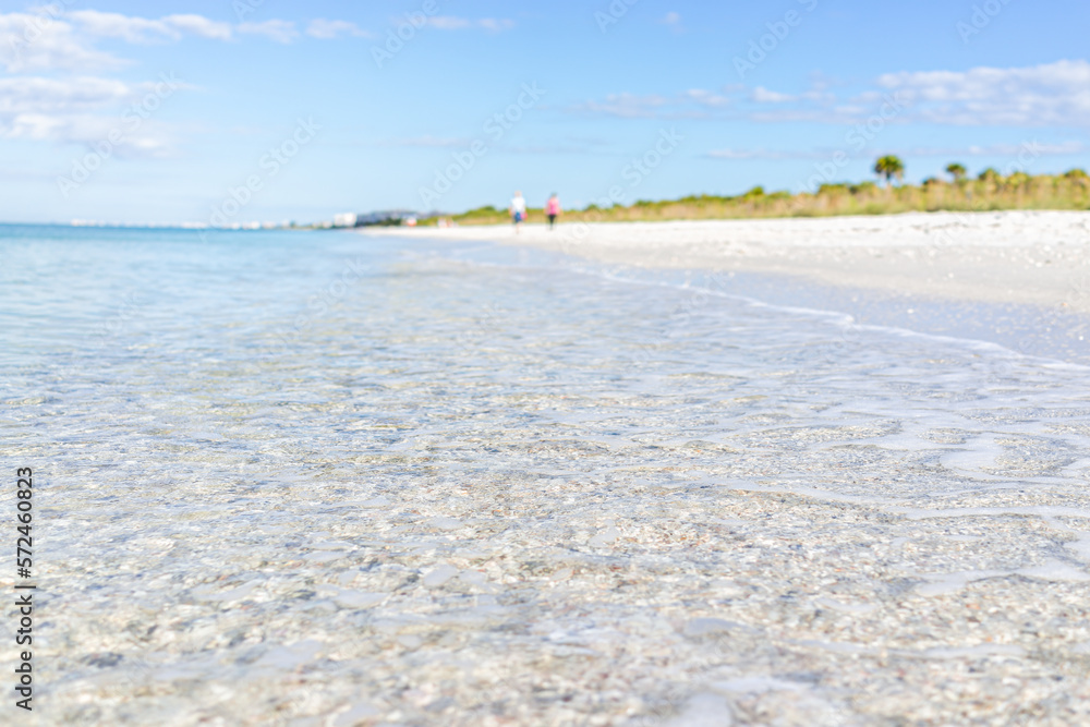 Crystal clear transparent blue water of Gulf of Mexico at Barefoot Beach, Southwest Florida near Bonita Springs and blurry background on sunny day Crystal clear transparent blue water of Gulf of Mexico at Barefoot Beach, Southwest Florida near Bonita Springs and blurry background on sunny day