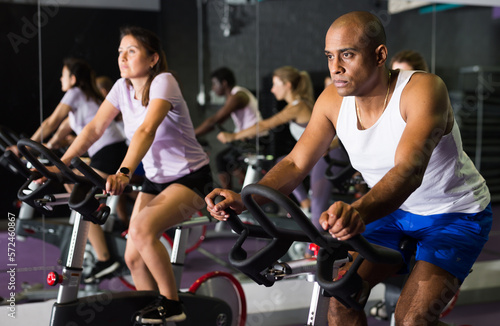 Man ride stationary bike in a fitness club