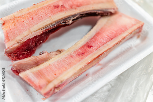Tableau sur toile Packaged raw beef marrow bones for roasting macro closeup with texture of pink r