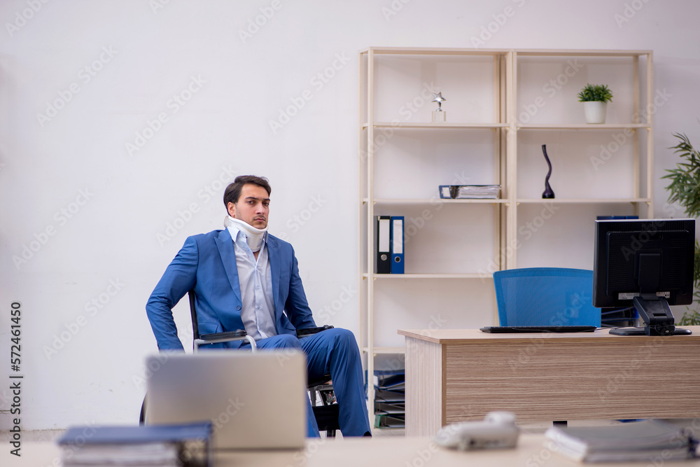 Young male employee after car accident at workplace Young male employee after car accident at workplace