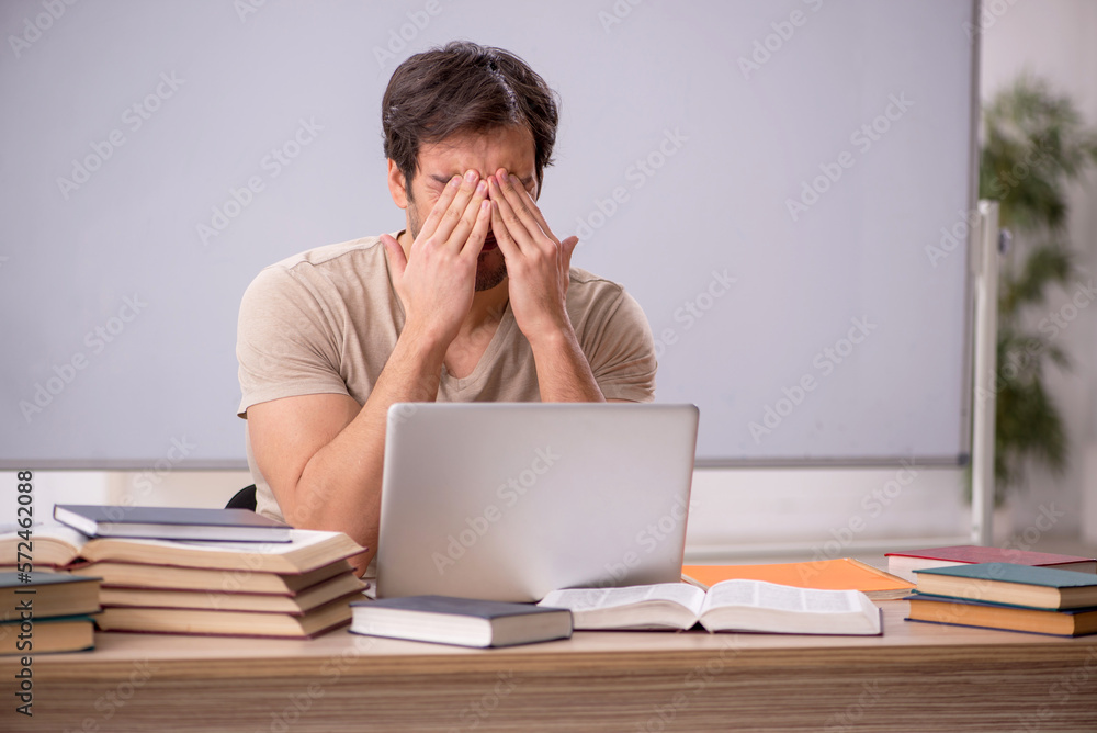 Young male student in tele-education concept Young male student in tele-education concept