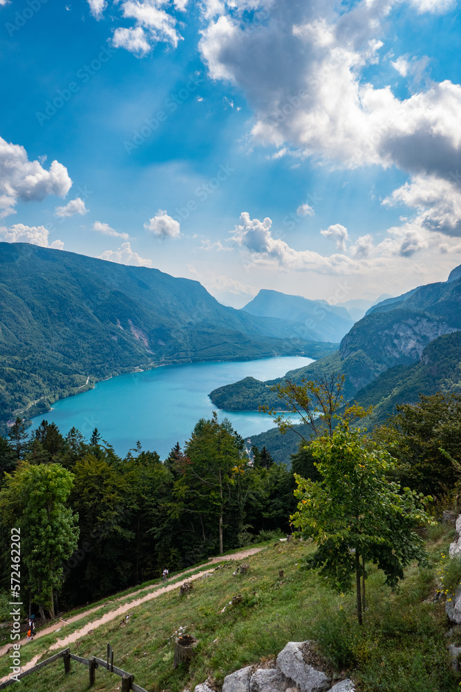 Idyllic view of beautiful Lake of Molveno, province of Trento, Trentino Alto-Adige, Italy, in a cloudy and sunny summer day, surrounded by Dolomiti del Brenta mountains Idyllic view of beautiful Lake of Molveno, province of Trento, Trentino Alto-Adige, Italy, in a cloudy and sunny summer day, surrounded by Dolomiti del Brenta mountains