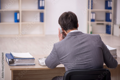 Young male employee working in the office