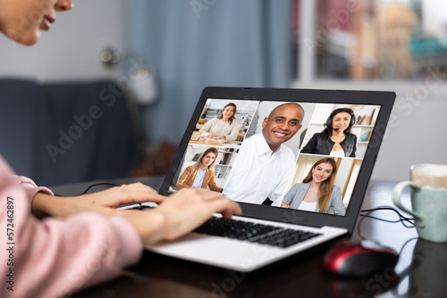 Young woman working at home on a laptop is holding a video conference discussing important current issues