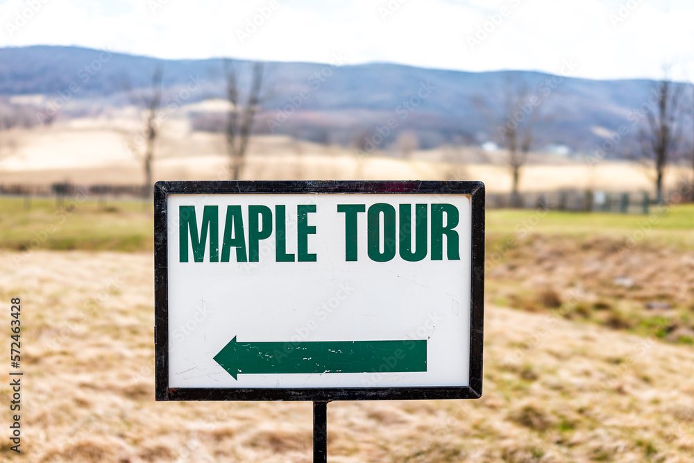 Maple syrup tour generic sign with direction arrow in Highland county, Virginia in spring season during festival with blue ridge mountains