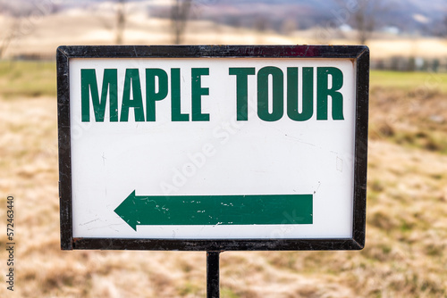 Maple syrup tour generic sign closeup with direction arrow and text in Highland county, Virginia in spring season during festival photo