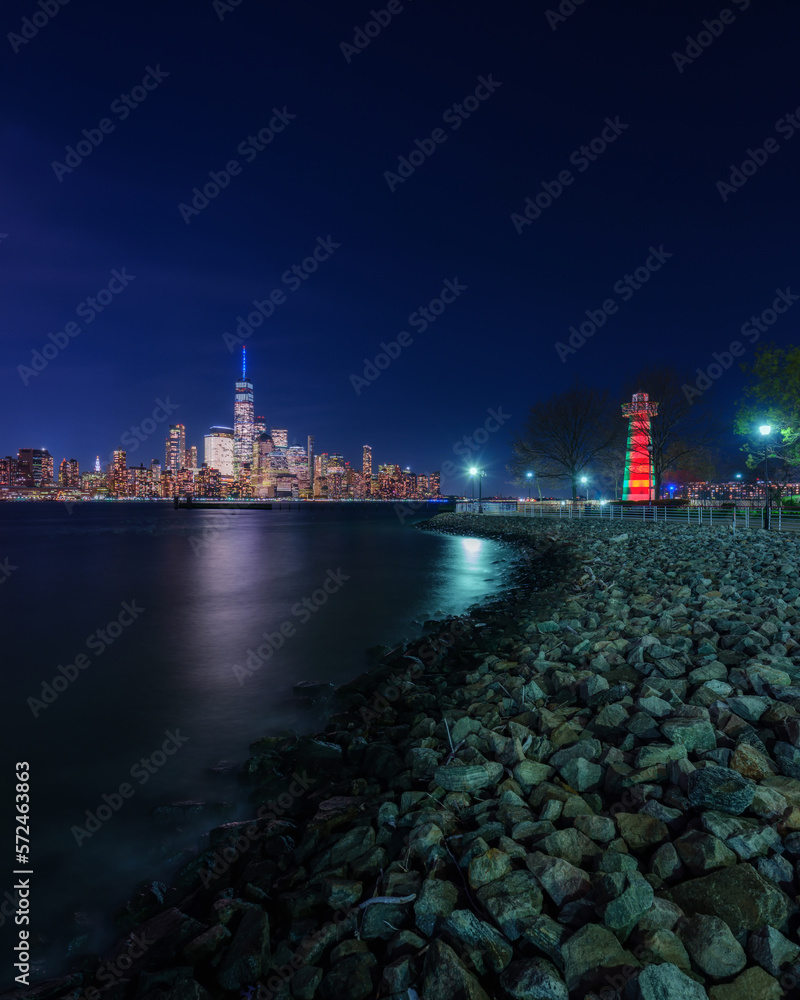 Financial district and lighthouse at night