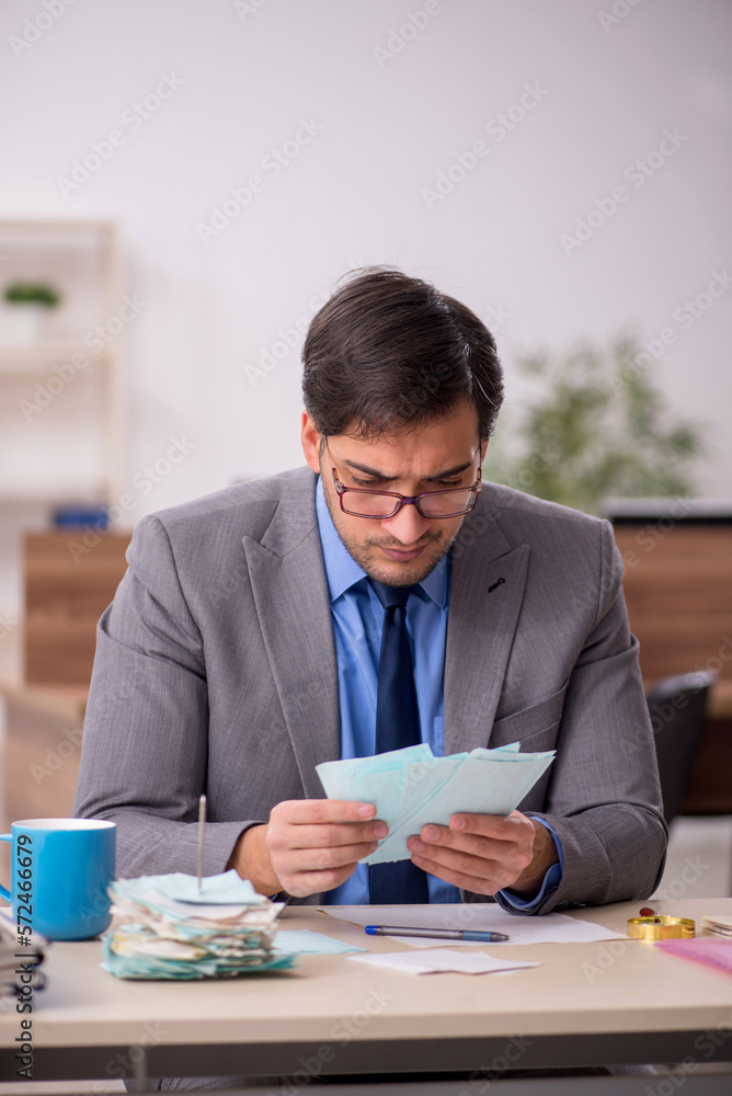 Young male accountant working in the office Young male accountant working in the office