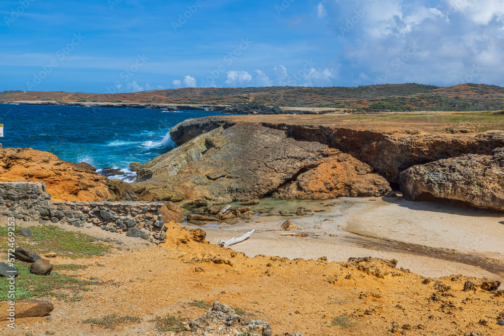 Gorgeous nature landscape view. Rocky coastline of Northern Aruba island on Caribbean sea background with destroyed natural Bridge. 