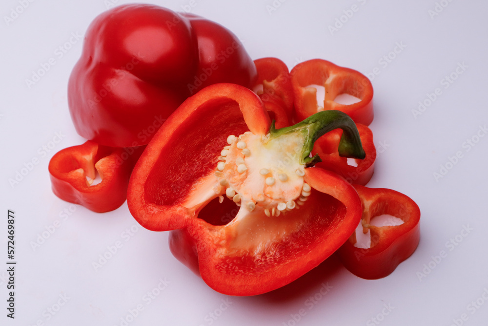 Slices of pepper and tomatoes on a white background Slices of pepper and tomatoes on a white background