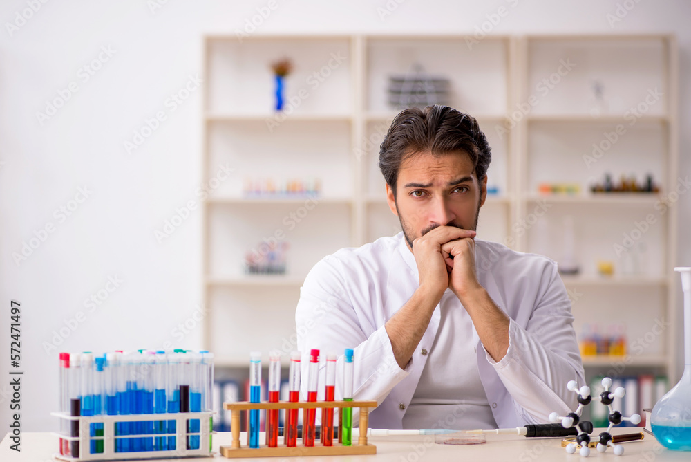Young male chemist working at the lab Young male chemist working at the lab
