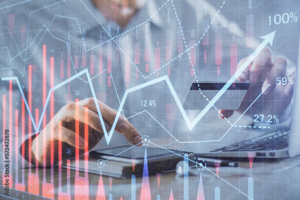 Double exposure of man hands holding a credit card and Forex graph drawing. Stock trading and digital fintech in Internet E-commerce concept. Double exposure of man hands holding a credit card and Forex graph drawing. Stock trading and digital fintech in Internet E-commerce concept.