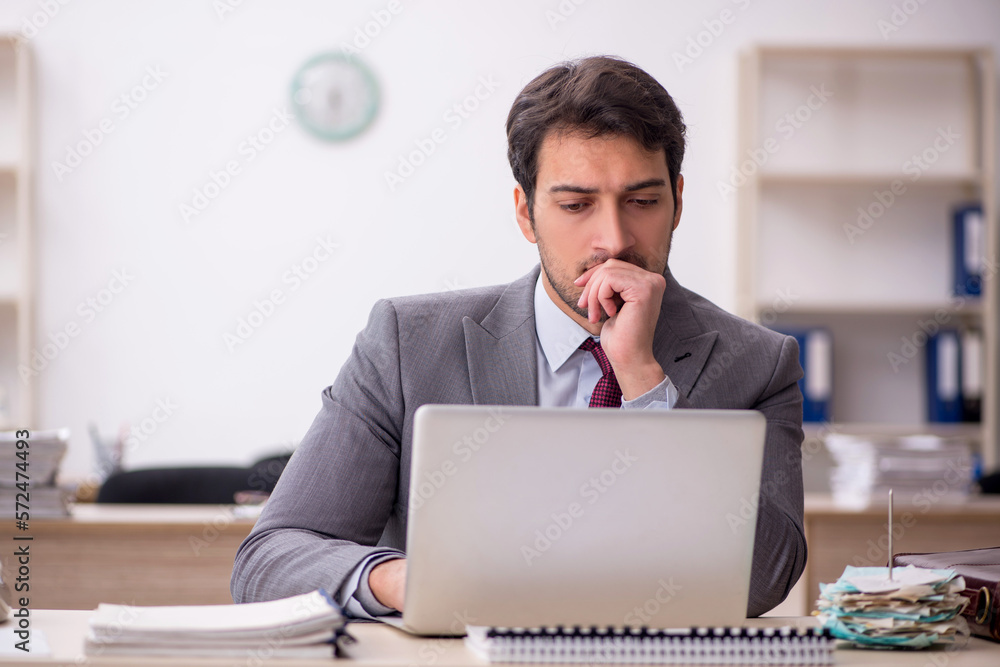 Young male employee working in the office Young male employee working in the office