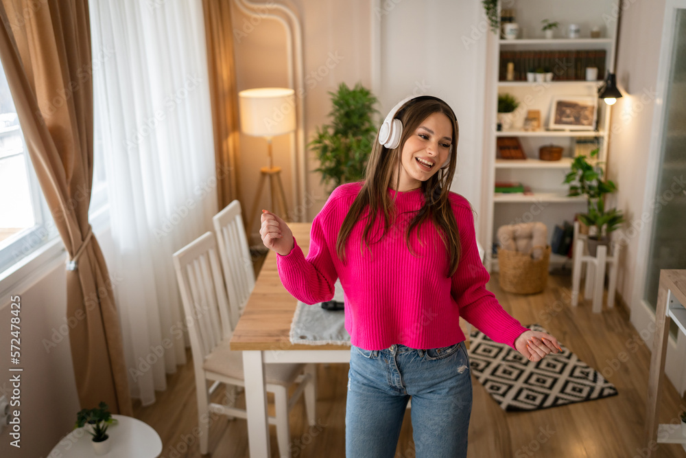 One young woman caucasian dance with headphones at home listen music One young woman caucasian dance with headphones at home listen music