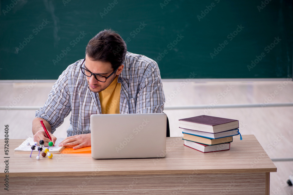 Young male student sitting in the classroom Young male student sitting in the classroom