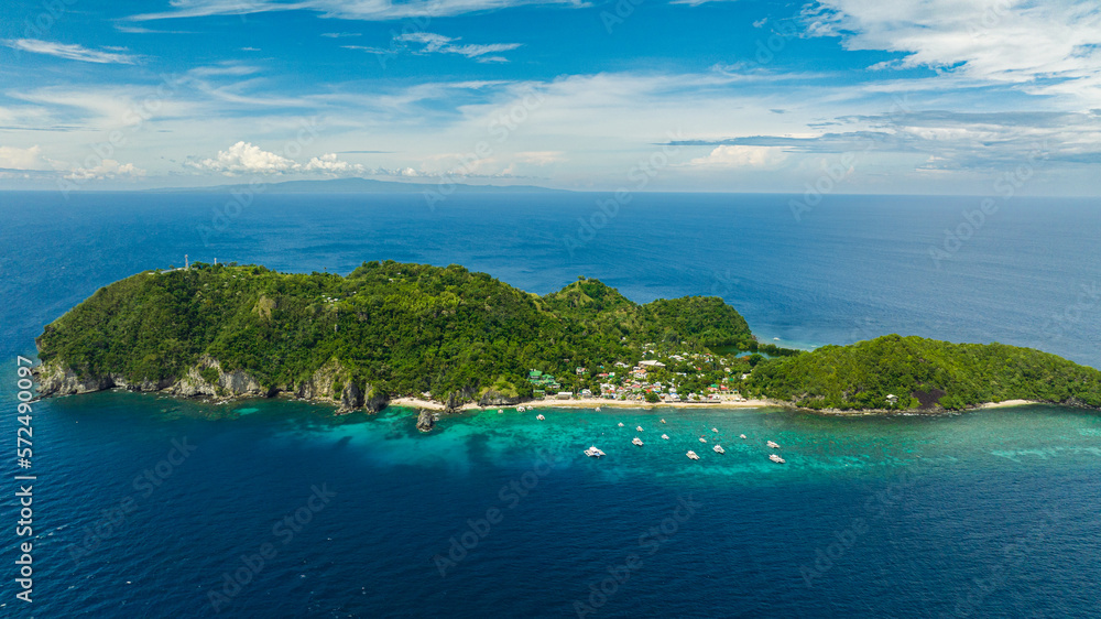Aerial drone of Apo Island with a beautiful beach and marine reserve. Popular dive site and snorkeling destination with tourists. Negros, Philippines.