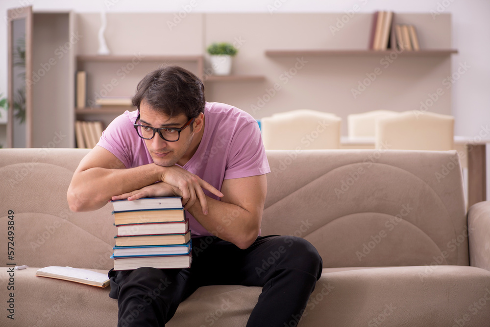 Young male student preparing for exams at home