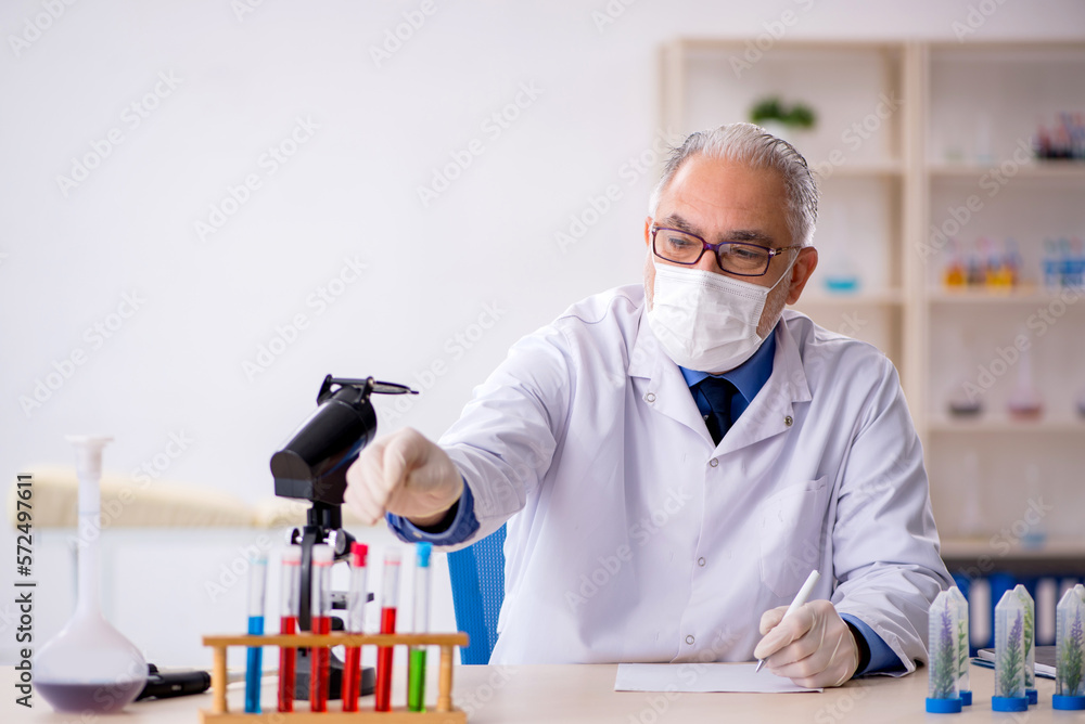 Old male chemist in drugs synthesis concept Old male chemist in drugs synthesis concept