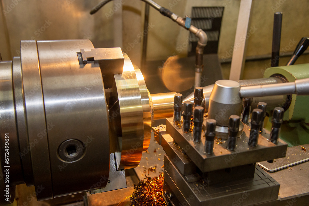 Fototapeta premium The lathe machine finish cut the brass parts by lathe tools.