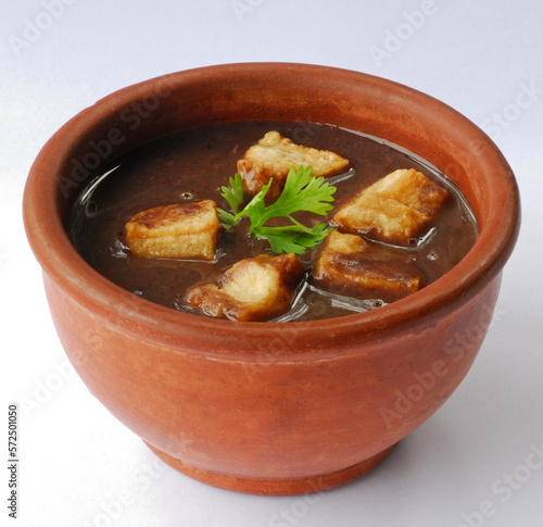 Brazilian bean broth in a clay bowl. Brazilian feijoada. photo