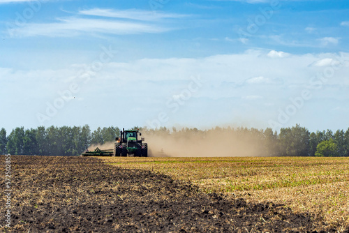 The tractor plows the land. Agriculture image.