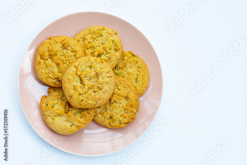 Pistachio and almond cookies on white background.