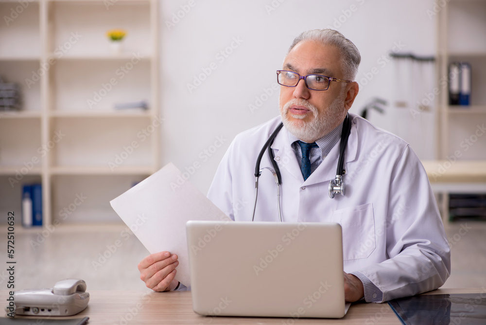 Old male doctor in telemedicine concept Old male doctor in telemedicine concept