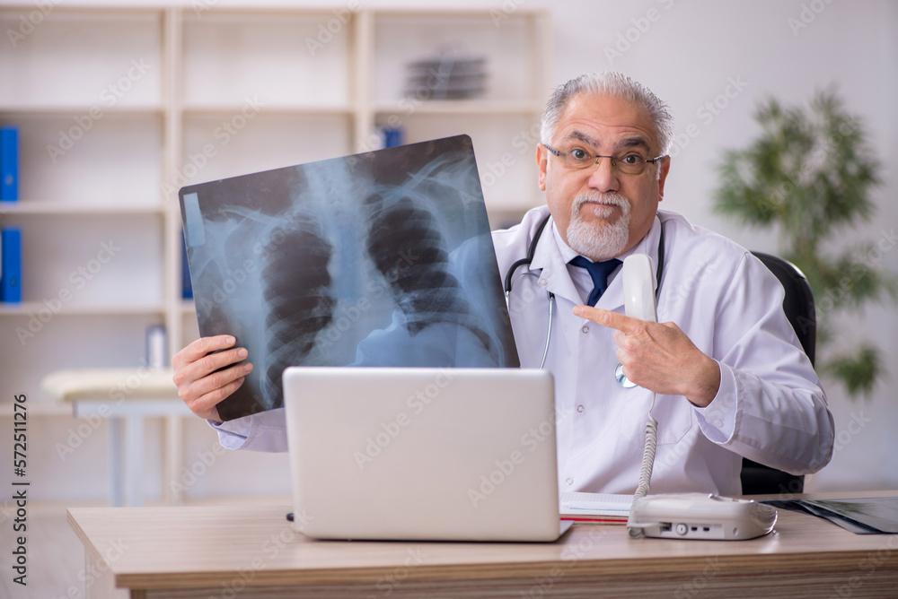 Old male doctor radiologist working in the clinic Old male doctor radiologist working in the clinic