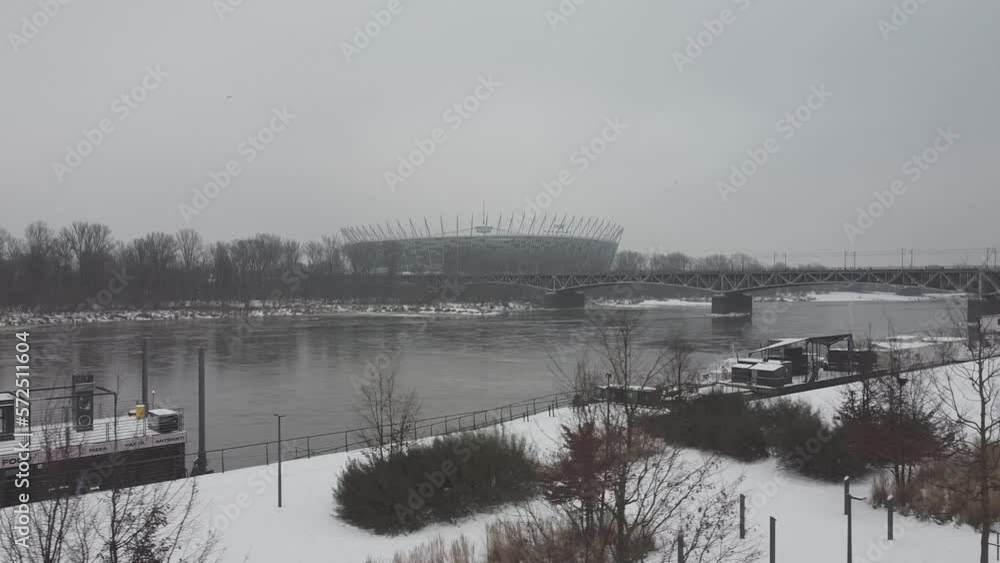 Drone video of warsaw national stadium on a snowy day above Vistula river Drone video of warsaw national stadium on a snowy day above Vistula river