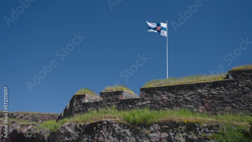 Old flag of Finland Waving With The Wind Against The Blue Sky. - wide static photo