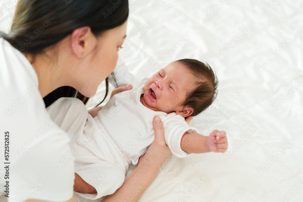 newborn baby crying while mother holding on bed newborn baby crying while mother holding on bed