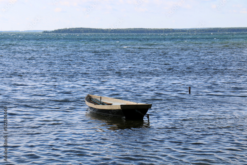 Naklejka premium Rowing boat on the shore of Lake Naroch.