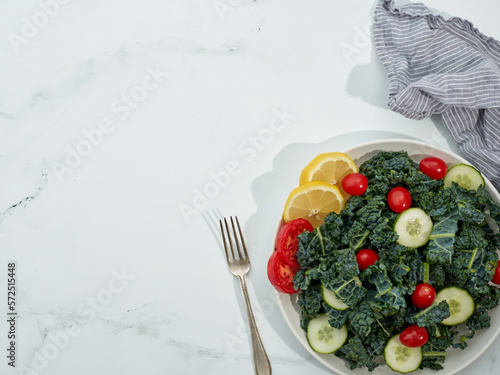 Dinosaur Kale Salad in bowl on white marble background