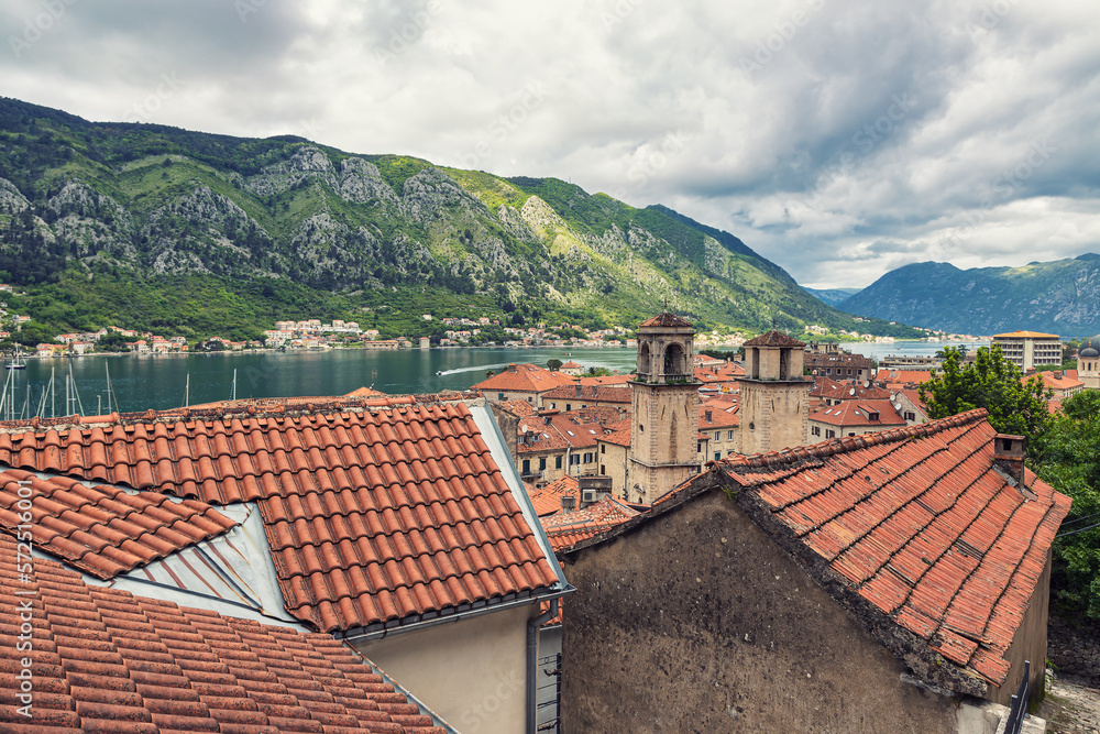 Rooftop view of Kotor historical center and beautiful bay surrounded by rocky mountains in Montnegro