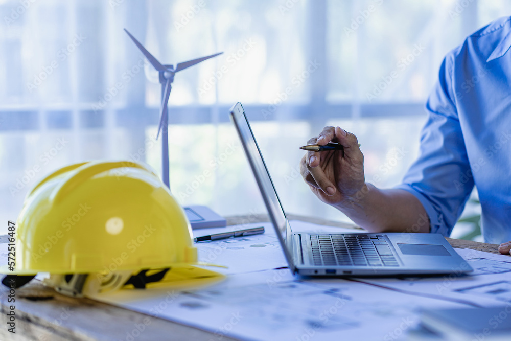 Male engineer pointing to blueprints on screen with house plans and ...