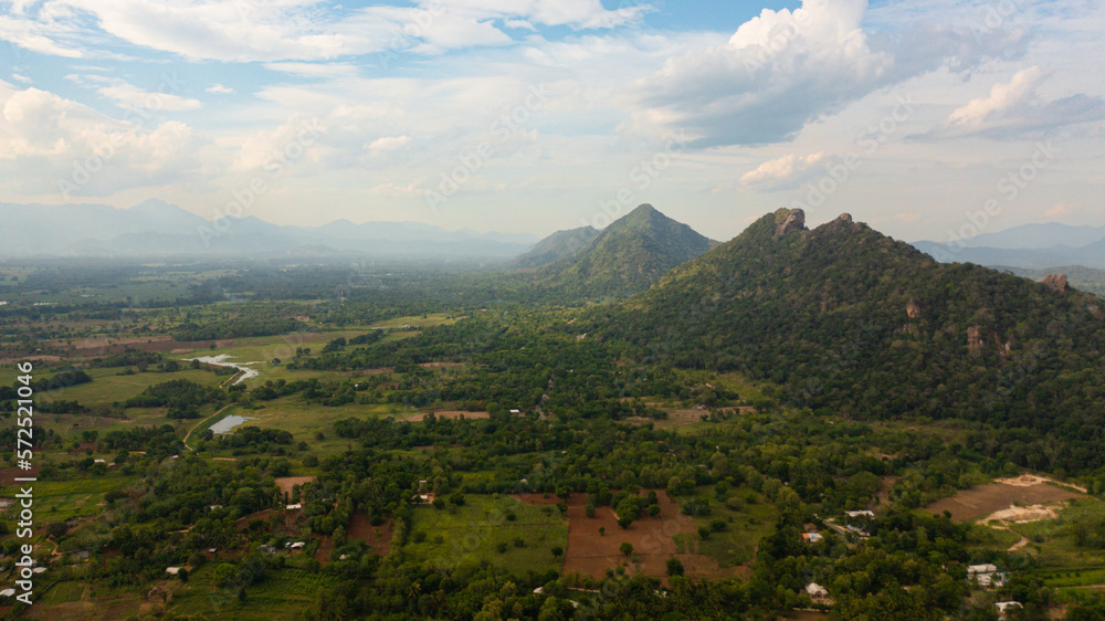 Top view of Mountain slopes with rainforest and a mountain valley with farmland. Sri Lanka