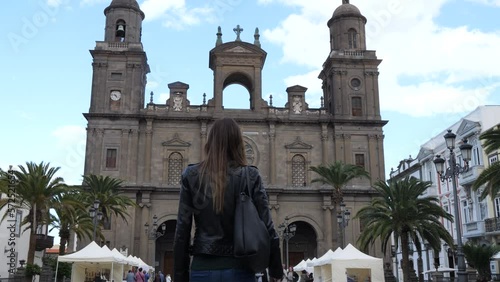 woman from behind walks towards the cathedral of santa ana in las palmas de gran canaria. Canary Islands, Spain. photo