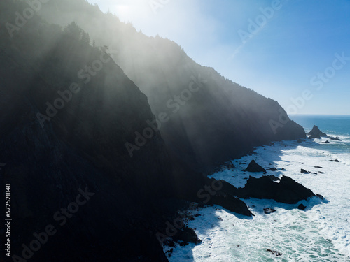 Afternoon sunlight shines on the southern coast of Oregon, along the Samuel H. Boardman State Scenic Corridor. This beautiful, rugged coastline is thickly forested and full of amazing viewpoints.