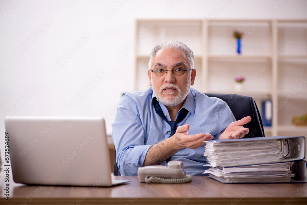 Old male employee and too much work in the office Old male employee and too much work in the office