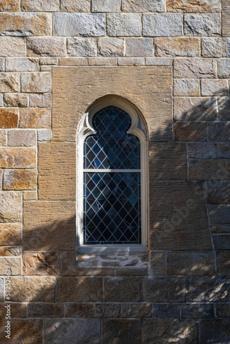 Wallpaper Mural window in the stone wall of the church with shadow of trees Torontodigital.ca